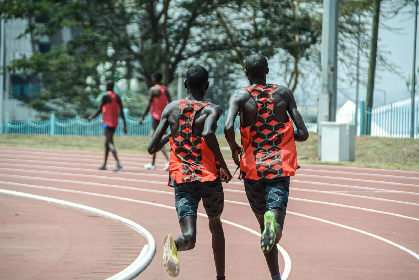 Runners training on an outdoor athletics track